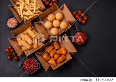 Fast food french fries, brie fries, cheese balls, cheese sticks and chicken nuggets 119600682