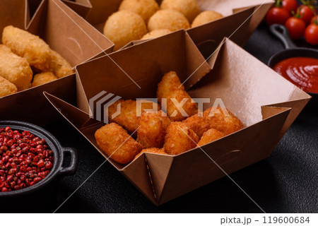 Fast food french fries, brie fries, cheese balls, cheese sticks and chicken nuggets 119600684