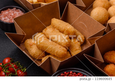 Fast food french fries, brie fries, cheese balls, cheese sticks and chicken nuggets 119600685