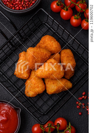Breaded camembert or brie cheese baked in the form of nuggets with salt and spices 119600702