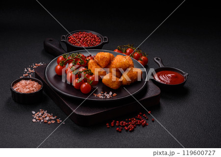 Breaded camembert or brie cheese baked in the form of nuggets with salt and spices 119600727