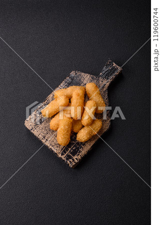 Fast food breaded cheese sticks with salt and spices 119600744