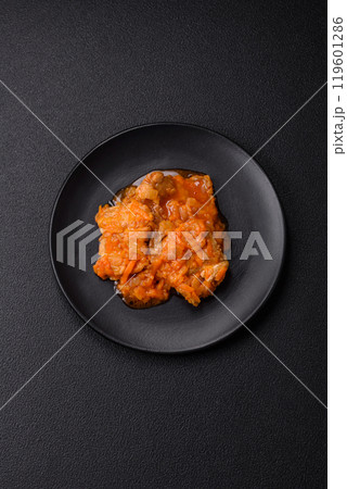 Sliced fish in tomato sauce with salt and spices Sliced fish in tomato sauce with salt and spices 119601286