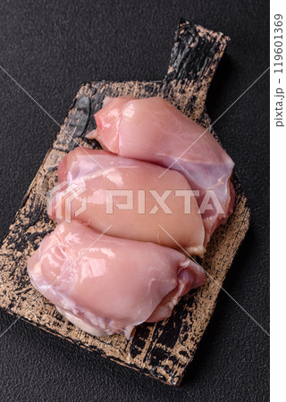 Fresh chicken fillet on a dark concrete table with spices and herbs 119601369