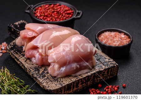 Fresh chicken fillet on a dark concrete table with spices and herbs 119601370