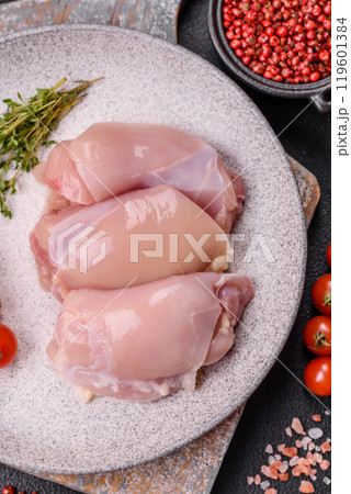 Fresh chicken fillet on a dark concrete table with spices and herbs 119601384