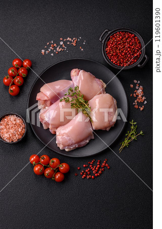 Fresh chicken fillet on a dark concrete table with spices and herbs 119601390