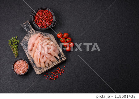 Raw chicken fillet cut into strips with spices and herbs 119601438