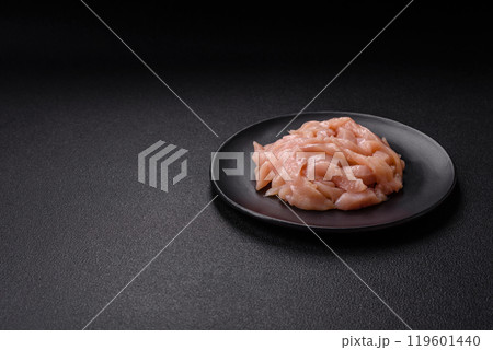 Raw chicken fillet cut into strips with spices and herbs Raw chicken fillet cut into strips with spices and herbs 119601440