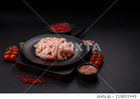 Raw chicken fillet cut into strips with spices and herbs 119601449