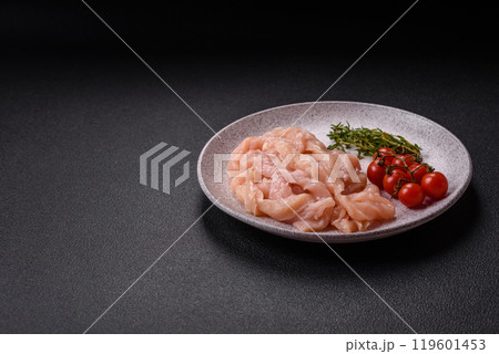 Raw chicken fillet cut into strips with spices and herbs Raw chicken fillet cut into strips with spices and herbs 119601453