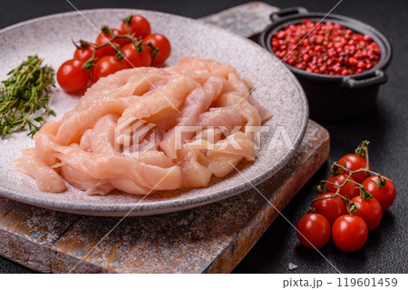 Raw chicken fillet cut into strips with spices and herbs 119601459
