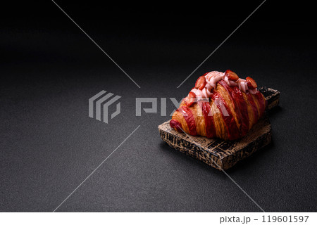 Crispy sweet red croissant with strawberry filling 119601597