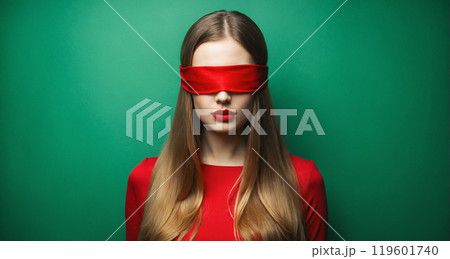 beautiful young woman in red blindfold, dress and lips. beauty portrait of mysterious girl 119601740