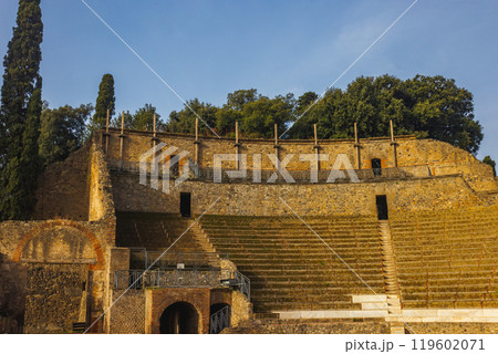 An ancient amphitheater beautifully surrounded by lush greenery, enriching the scene. City of Pompei An ancient amphitheater beautifully surrounded by lush greenery, enriching the scene. City of Pompei 119602071