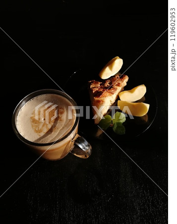 Сup of coffee tea on the table with a homemade cake decorated with a fresh mint Сup of coffee tea on the table with a homemade cake decorated with a fresh mint 119602953