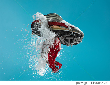 Hiking trail in winter should wear Crampons snow spike on shoes to protect slippery on ice icy surface road. Crampon spike shoe walk good on snow, blue sky background isolated 119603476