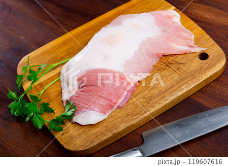 Fresh raw pork secreto fillet (Secreto de cerdo) and condiments prepared for roasting 119607616