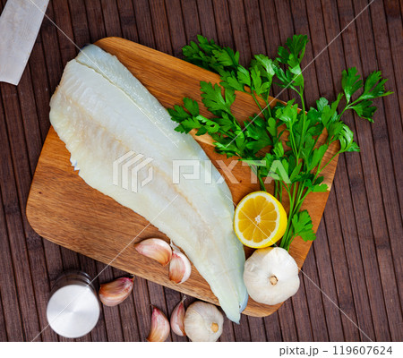 Fresh cod fillet with seasonings ready for cooking 119607624