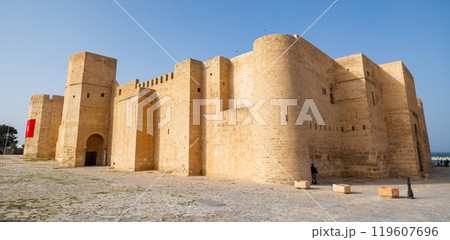 Ribat Hartema Fortress - one of main attractions of Monastir. Powerful defensive structure protecting city from enemies from sea. Side view Ribat Hartema Fortress - one of main attractions of Monastir. Powerful defensive structure protecting city from enemies from sea. Side view 119607696