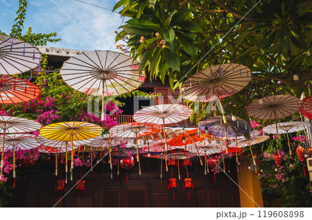 Colorful decorative Asian Japanese umbrellas decorate street in Hoi an in Asia 119608898