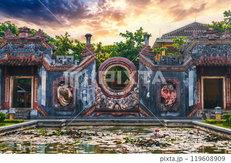 Beautiful Ancient Asian gate to Buddhist pagoda in Hoi An old town in Vietnam in Asia at sunrise in summer 119608909