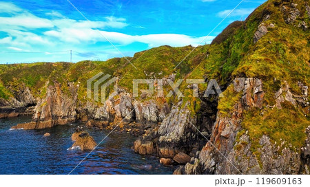 Enjoy the breathtaking view of a stunning coastal landscape with rocky cliffs and serene waters 119609163