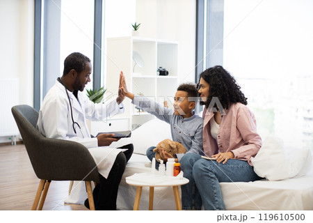 African boy giving high five during successful doctor visit 119610500
