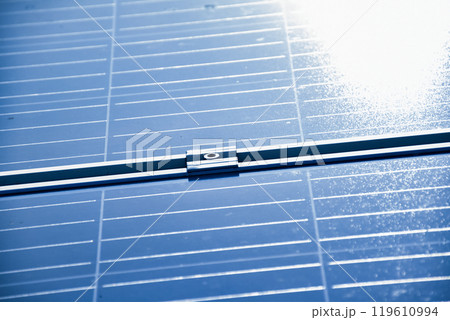 closeup photovoltaic panels which installed on the rooftop of the building, concept for storing and using natural power from the sunlight to care about human environment over the world. closeup photovoltaic panels which installed on the rooftop of the building, concept for storing and using natural power from the sunlight to care about human environment over the world. 119610994