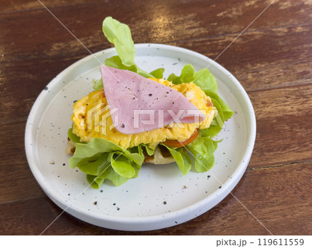 croissant with chicken sausage, ham, omelet and vegetables,tomato . The concept of breakfast croissant with chicken sausage, ham, omelet and vegetables,tomato . The concept of breakfast 119611559