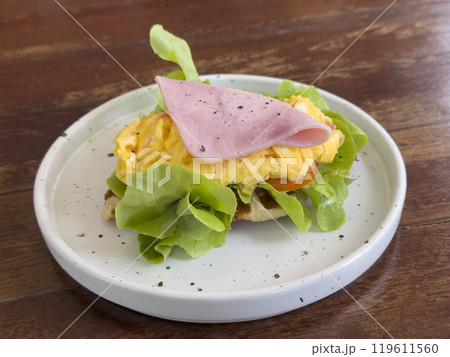 croissant with chicken sausage, ham, omelet and vegetables,tomato . The concept of breakfast croissant with chicken sausage, ham, omelet and vegetables,tomato . The concept of breakfast 119611560