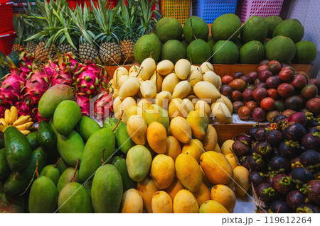 assortment of tropical fruits on market in Asia. Exotic fruits on counter in a street store in Vietnam. Mango, pitahaya, pineapple, mangosteen and passion fruit 119612264