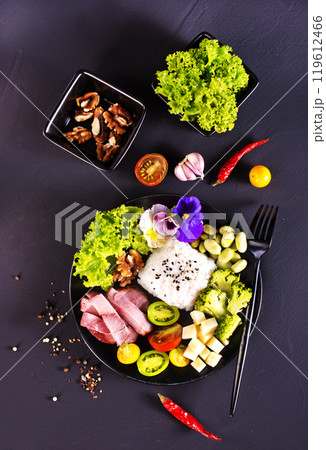 Salad with cheese, ham and rice. Serving food in a restaurant 119612466