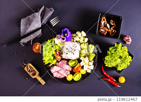 Salad with cheese, ham and rice. Serving food in a restaurant 119612467