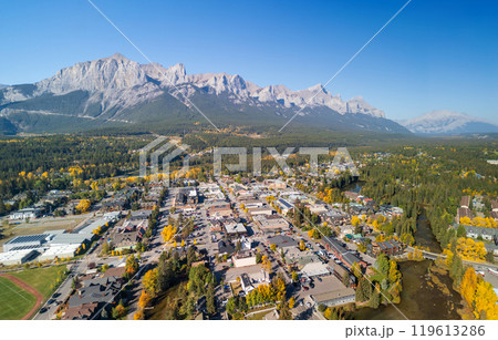 Aerial view of Town of Canmore downtown area in a autumn sunny day. Canadian Rockies mountain range in background. Alberta, Canada. Mount Rundle. 119613286