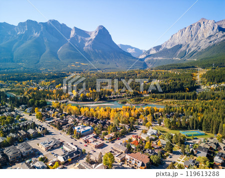 Aerial view of Town of Canmore downtown area in a autumn sunny day. Canadian Rockies mountain range in background. Alberta, Canada. 119613288