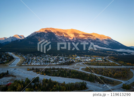 Aerial view of Grotto Mountain and Trans-Canada Highway (Highway 1) interchange exit 91 to Town of Canmore at dawn. Canadian Rockies, Alberta, Canada. Aerial view of Grotto Mountain and Trans-Canada Highway (Highway 1) interchange exit 91 to Town of Canmore at dawn. Canadian Rockies, Alberta, Canada. 119613290