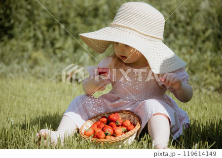 The Joyful Little Girl in a Straw Hat Enjoying 119614149