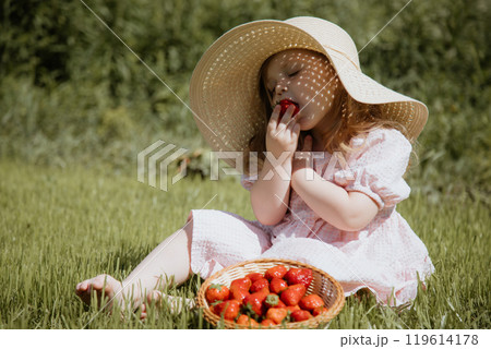The Joyful Little Girl in a Straw Hat Enjoying 119614178