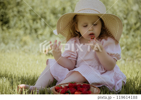 The Joyful Little Girl in a Straw Hat Enjoying The Joyful Little Girl in a Straw Hat Enjoying 119614188