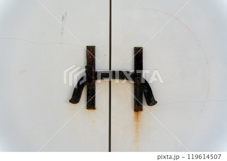 白い蔵の扉と錆びた閂 119614507