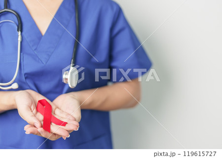 Doctor with Red Ribbon for December World Aids Day, acquired immune deficiency syndrome, multiple myeloma Cancer Awareness month and National Red ribbon week. Healthcare and world cancer day concept 119615727
