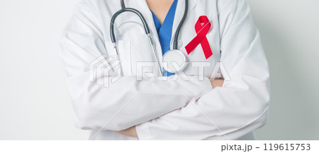 Doctor with Red Ribbon for December World Aids Day, acquired immune deficiency syndrome, multiple myeloma Cancer Awareness month and National Red ribbon week. Healthcare and world cancer day concept Doctor with Red Ribbon for December World Aids Day, acquired immune deficiency syndrome, multiple myeloma Cancer Awareness month and National Red ribbon week. Healthcare and world cancer day concept 119615753