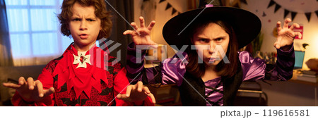 Scowling Halloween witch and demon 119616581