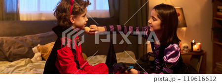 Helping boy prepare for Halloween party 119616612