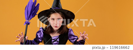 Clawing little witch with broom 119616662