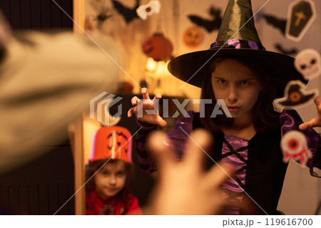 Little witch clawing and scowling 119616700