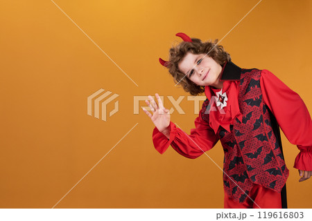 Halloween demon or vampire waving hand 119616803