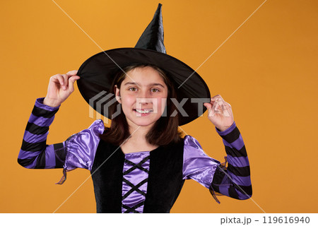 Cute girl in witch dress and black hat 119616940