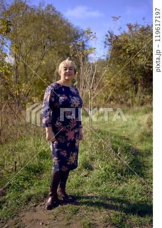 a portrait of an elderly woman with gray hair in a dress in the autumn forest a portrait of an elderly woman with gray hair in a dress in the autumn forest 119617197